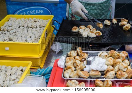 Street food : Crispy fried dumpling in hot pan fry at the night market