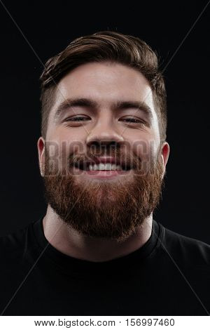 Close up trainer. smiling man in studio. isolated dark bavkground