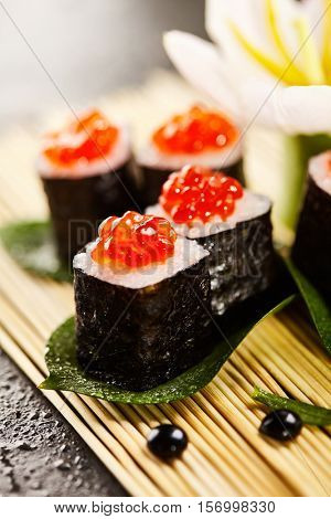 Ikura Maki Sushi - Roll with Cream Cheese inside. Topped with Ikura (Salmon Roe)