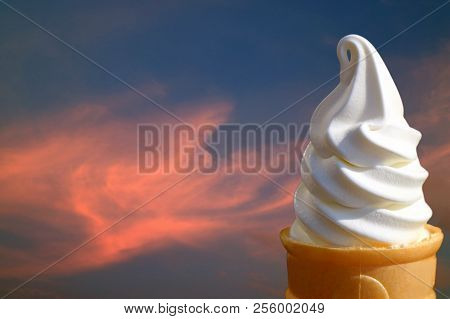 Pure White Vanilla Soft Serve Ice Cream Cone Against Sunset Afterglow Cloudy Sky