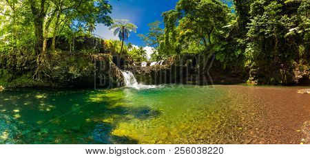 Vibrant Togitogiga falls with swimming hole on Upolu, Samoa Islands