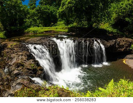 Vibrant Togitogiga falls with swimming hole on Upolu, Samoa Islands