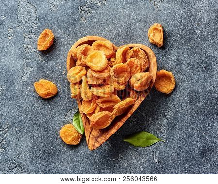 Dried Apricots On Gray Concrete Background. Top View.