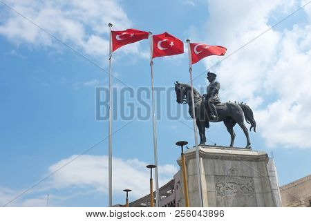 The statue of Ataturk and national flags of modern Turkey in Ulus - Ankara, Turkey