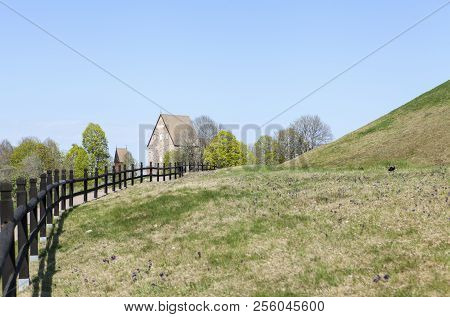 Outdoor View At Old Upsala Protection Area, The Kings Mounds. Fence And Church.