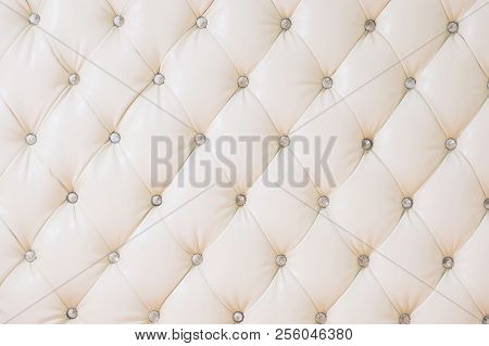 Beige Soft Tapestry Pattern Background With Symmetrical Buttons On The Corners Of Diamonds. Soft And