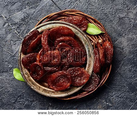 Dried Brown Apricots On Gray Background. Top View.