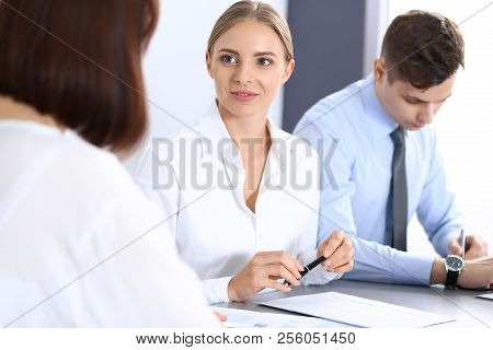 Group Of Business People Or Lawyers Discussing  Terms Of Transaction In Office. Meeting And Teamwork