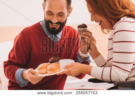 Happy Mid Aged Couple Eating A Dessert