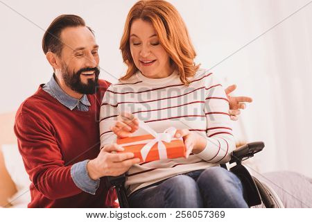 Cheerful Disabled Woman Opening Her Birthday Present