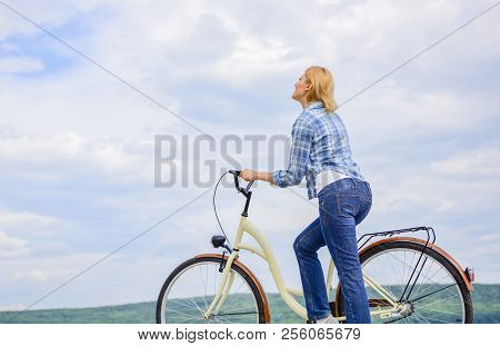 How To Learn To Ride Bike As An Adult. Woman Rides Bicycle Sky Background. Active Leisure. Girl Ride