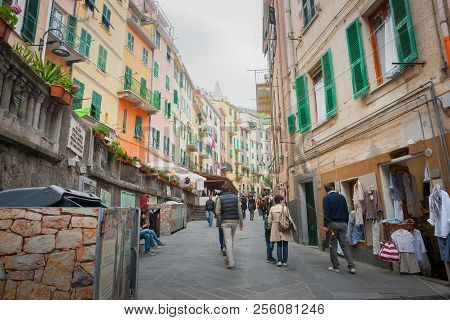Riomaggiore Italy - April 24 2011;  People Passing Along Narrow Lane Between Characteristic Mediterr