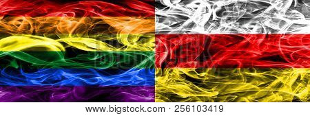 Gay Vs South Ossetia Smoke Flags Placed Side By Side. Thick Colored Silky Smoke Flags Of Gay And Sou