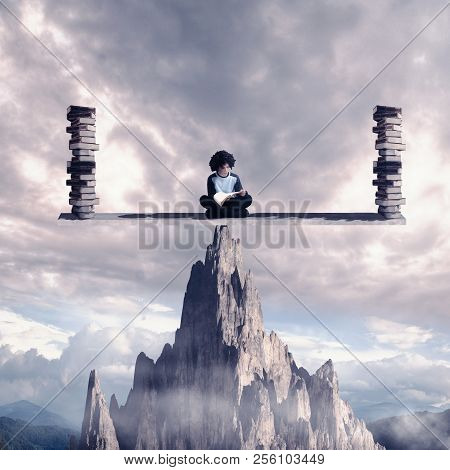 Stundent Reading A Book On Balance Scale Above A Mountain Rock. Knowledge Is Power Concept.