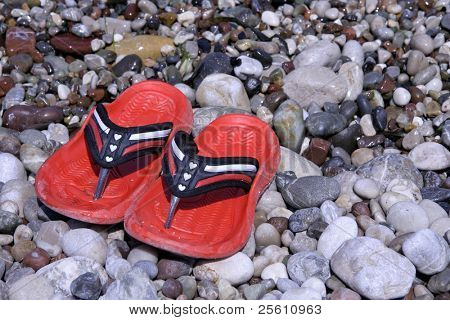 red heart shoes on pebble beach