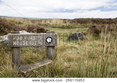 A Wooden Sign Post Signifying That Is Is 100 Meters To Hob Hurst`s House In The Peak District
