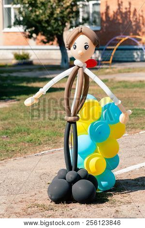 Balloon Man Dolly In The Summer Sun On School Garden