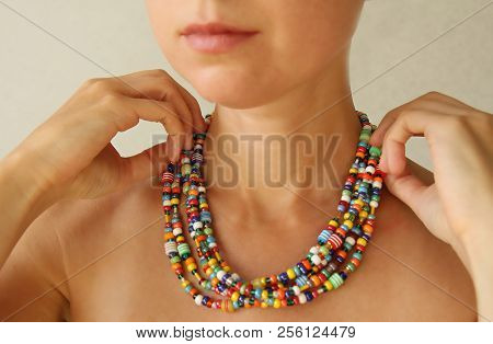 Bright Beads Of Murano Glass On A Young Girl. A Girl Dresses And Button Beads, Jewelry