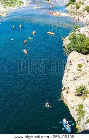 Remoulins,france-august 12, 2016:people Swim And Canoe Near The Pont Du Gard Roman Aqueduct During A