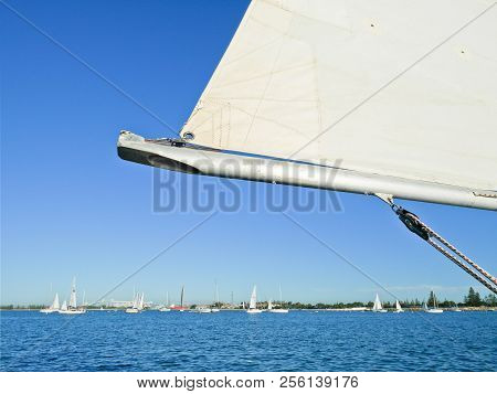 White Sail On Blue Skies And Sea Background