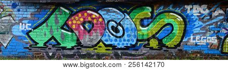Full And Acomplished Graffiti Artwork. The Old Wall Decorated With Paint Stains In The Style Of Stre