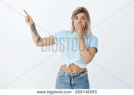 Omg, What Happened There. Portrait Of Shocked Worried Attractive Female With Tattoos And Pierced Bel