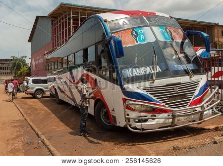 Kampala, Uganda - April 22, 2017: An Older Part Of Kampala A Colorful Bus Is Parking Near The Old Ro