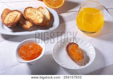 Morning Breakfast Set With Orange Jam On Bread Toast And Juice In Glass.