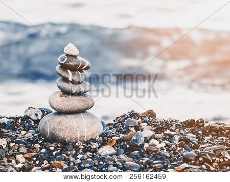 Pyramid Of Pebbles On The Beach.waves In Background. Retro Style.