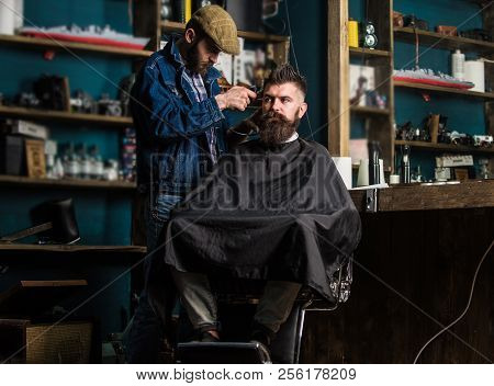 Barber With Clipper Trimming Hair On Temple Of Bearded Client. Hipster Client Getting Haircut. Barbe