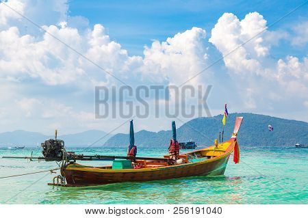 Traditional Long Tail Boat On Coral (ko He) Island Near Phuket Island, Thailand In A Summer Day