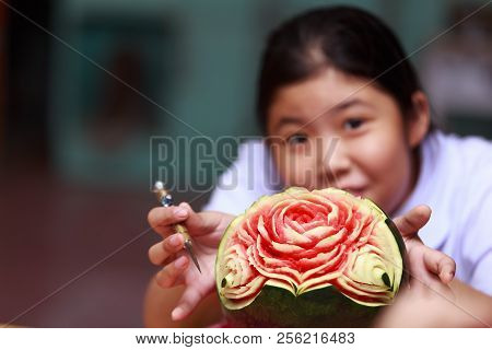 Asian Little Girl Carve Fruit In School