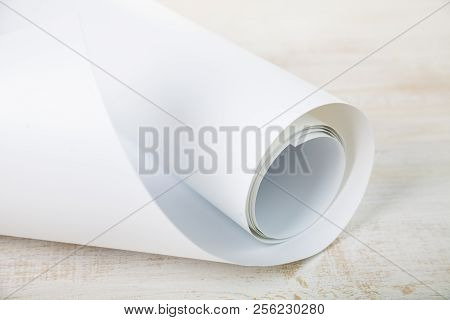 Roll Of White Paper On A Wooden Background.