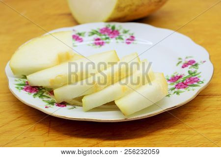 Melon Is A Warm And Light-loving Plant. Slices Of Melon On A Plate.
