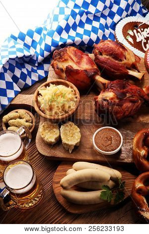 Traditional German Cuisine, Schweinshaxe Roasted Ham Hock. Beer, Pretzels And Various Bavarian Speci