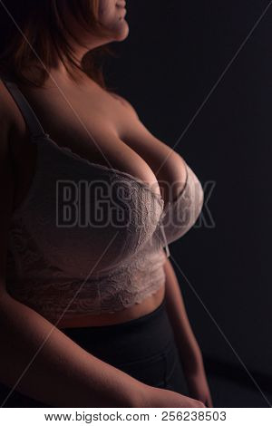 Young Beautiful Busty Curvy Plus Size Model With Big Breast In White Bra, Xxl Woman. Black Backgroun