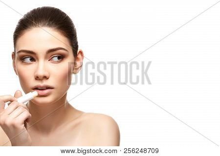 Girl Applying Pink Lipstick Isolated On White