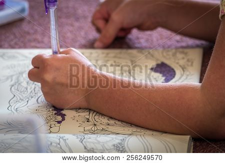 Mother And Chikd Colouring Together In A Book