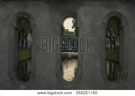View Over The Water Lined With Trees At Königsallee, Dusseldorf, Germany Through The Opening On The 