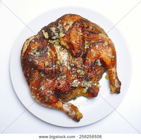 Grilled Fried Roast Chicken Tabaka On White Plate