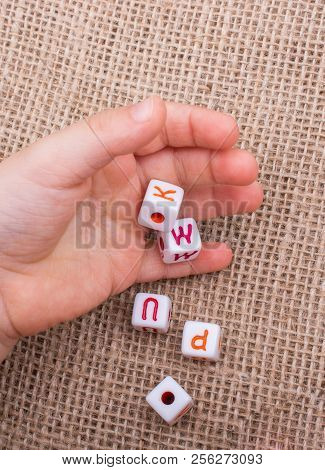 Colorful Alphabet Letter Cubes In Handon A  Canvas Background