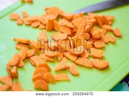 Preparation Of Dishes From Sliced Fresh Carrots. Knife, Carrots On The Cutting Board, Sliced And Gra