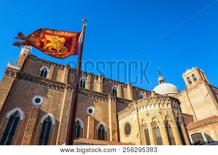 Flag Of Venice Near The Basilica Di San Giovanni E Paolo In Venice, Italy. This Old Church Is One Of