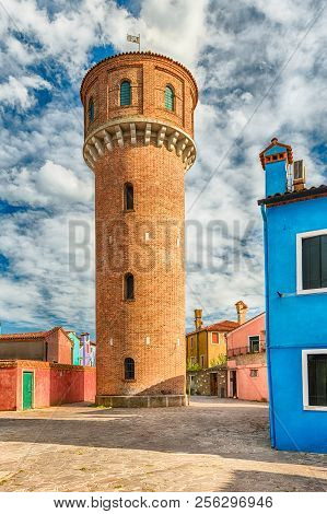 Water Tower On The Island Of Burano, Venice, Italy. The Island Is A Popular Attraction For Tourists 