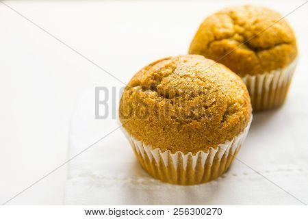 Homemade Whole Wheat Bran Carrot Muffin On White Cotton Kitchen Towel. Breakfast Morning Sunlight. H