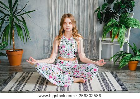 Young Woman Meditates In Easy Pose In Boho Interrior. Yoga At Home Concept.