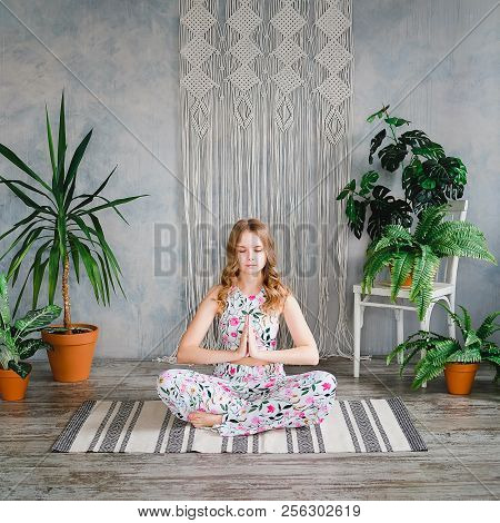 Young Woman Meditates In Easy Pose In Boho Interrior. Yoga At Home Concept.