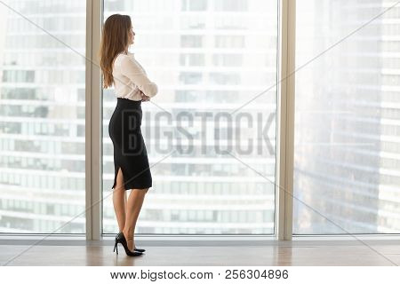 Successful Beautiful Businesswoman Standing Looking Out Of Windo