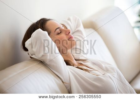Calm Millennial Woman Relaxing On Comfortable Sofa Breathing Fre