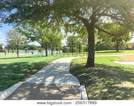 Green Park With Pathway From Shady Parking Lots In Coppell, Texas, Usa